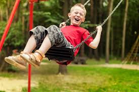 Kid swinging at the playground